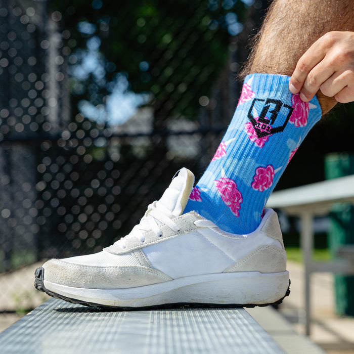 Adult model wearing multi-color socks with "Cotton Candy Performance 3-Pack" design