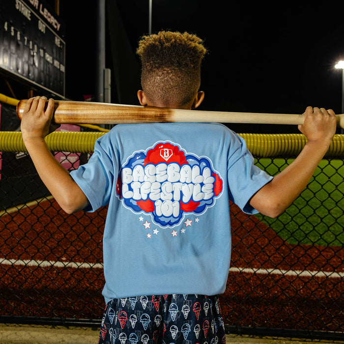 Youth model wearing red, white & blue Cotton Candy Light Blue youth graphic tee