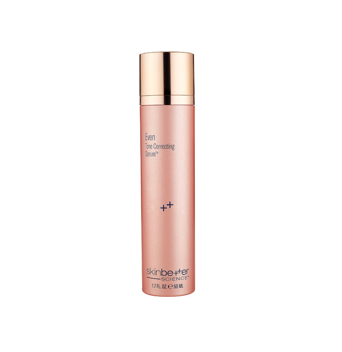 Skincare bottle with gold cap and pink body on a white background