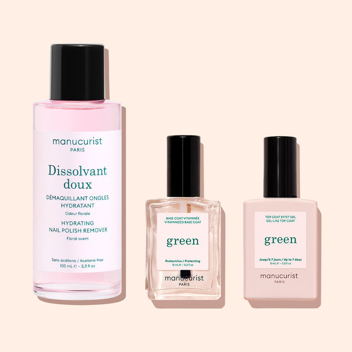 Three manicure products from Manucurist: a pink bottle of Gentle Remover (acetone-free), plus two square green bottles (base coat and top coat to strengthen nails), all set on a light background.