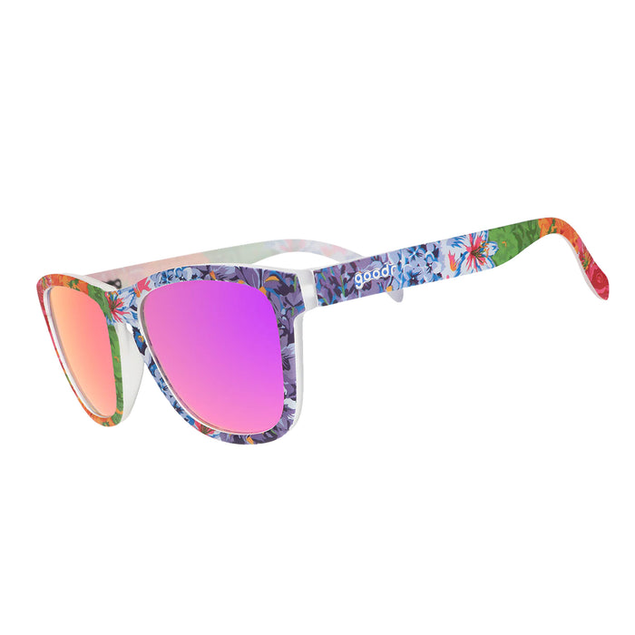 Sunglasses with colorful floral frame and pink lenses on a white background