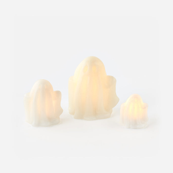 Three lightbulb-shaped candles on a white background