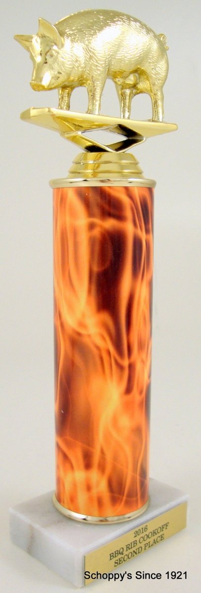 A gold-colored trophy featuring a flying pig motif atop a flame column, with an engraved plate at the base.