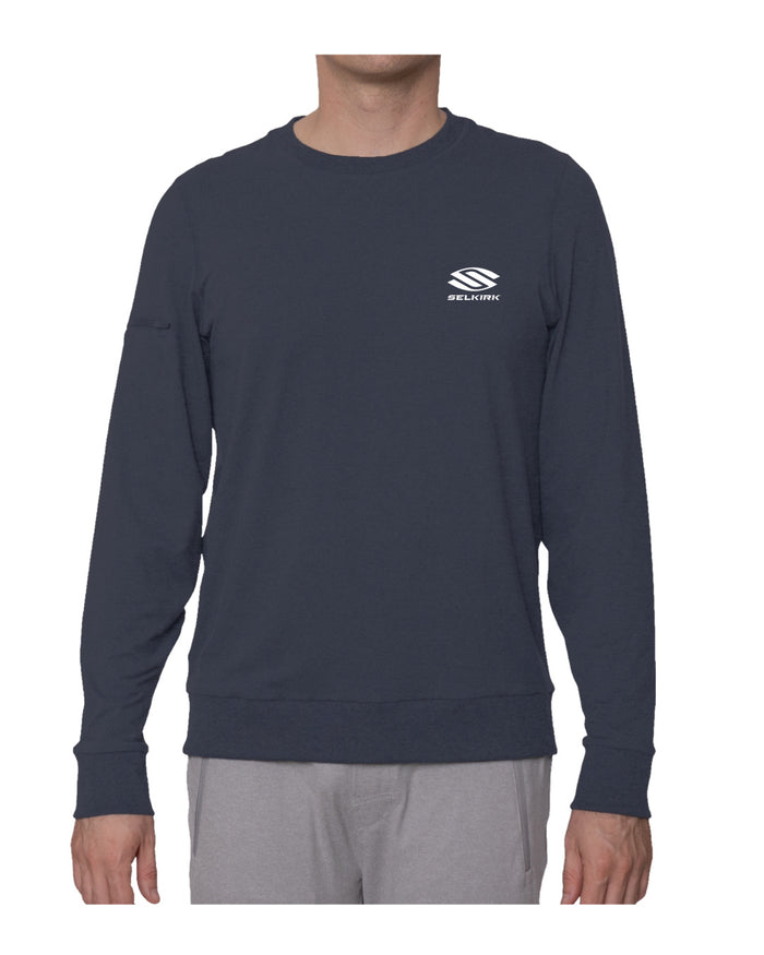 Navy long-sleeve sweatshirt on male model with small white SELKIRK logo on left chest.