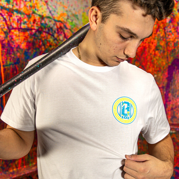Man wearing a white t-shirt with a BL101 logo, holding a baseball bat against a colorful abstract background