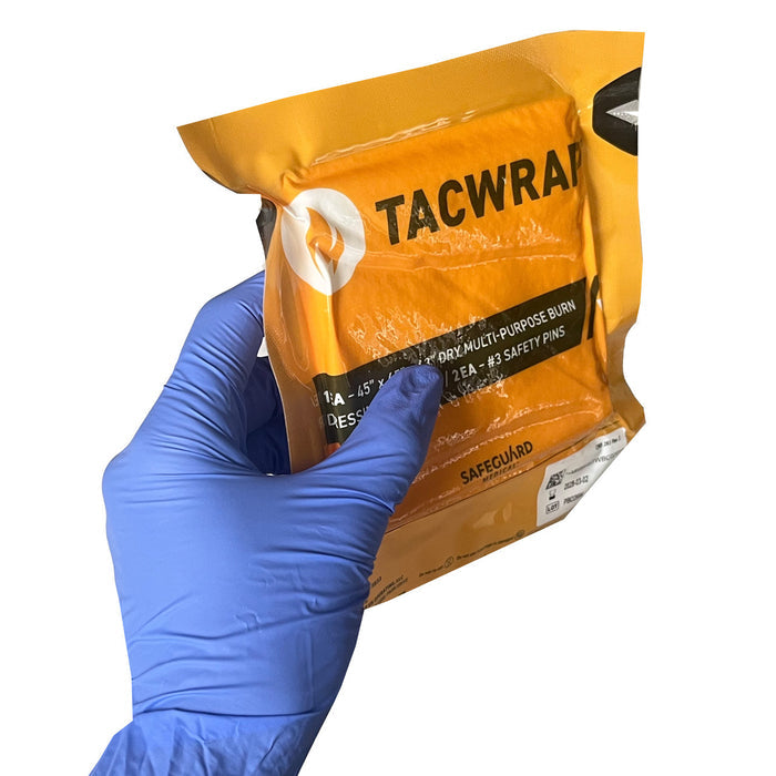 TACWrap Multi-purpose Dry Burn Dressing/Cravat in packaging being held in hand