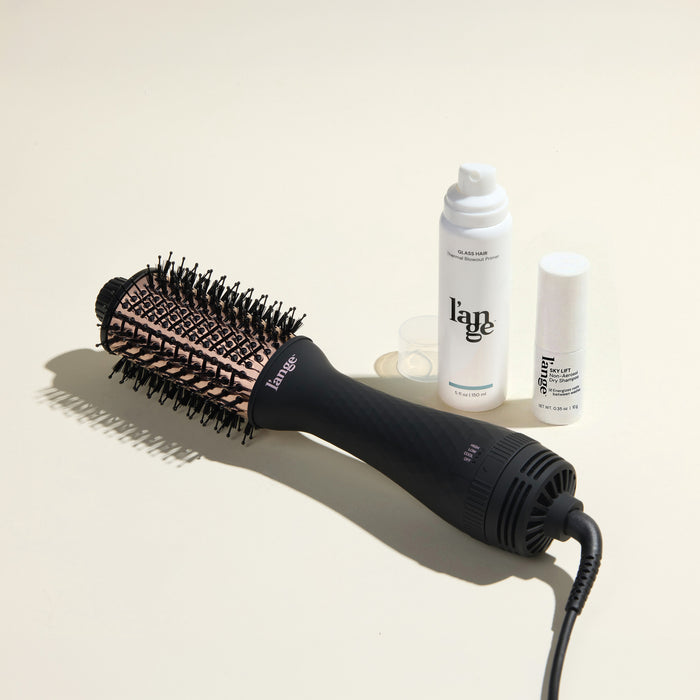The Fresh Blowout Trio Value Set featuring a Black 60mm Le Volume, Glass Hair, and Sky Lift, displayed on a beige background.