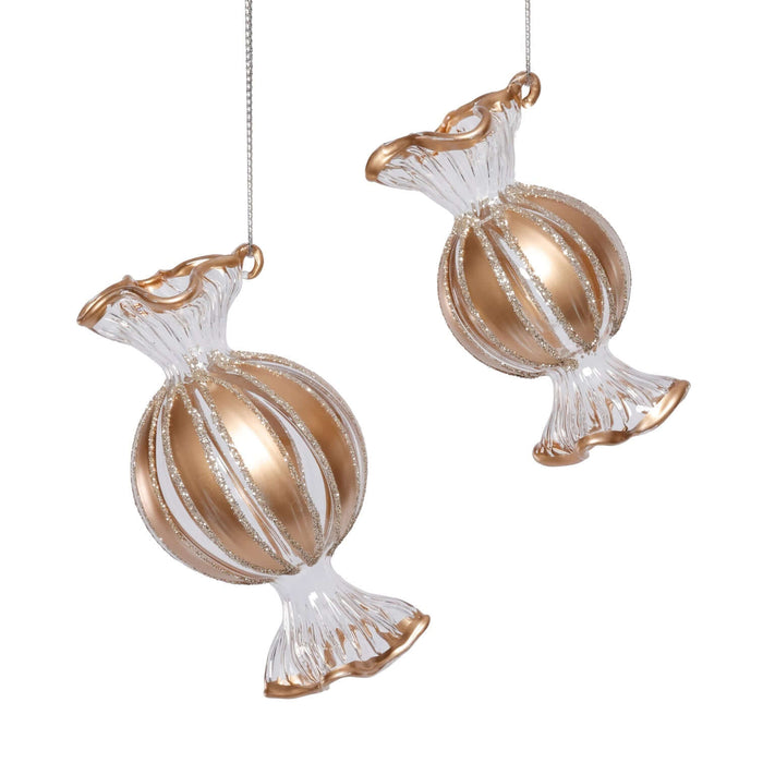 Two glass candy ornaments with gold and clear design on a white background