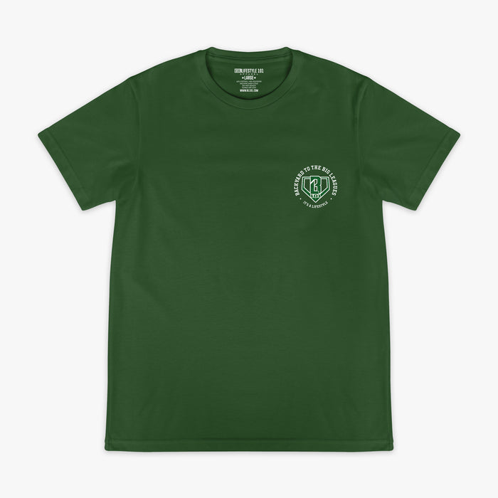 Front flat lay of the BL101 Backyard to the Big Leagues forest green tee, showing the BL101 logo on a white background.