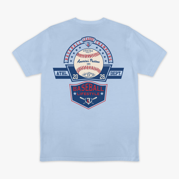 ack flat lay of the BL101 Baseball League Champions light blue tee, featuring a vintage-style "America's Pastime" baseball and Baseball Lifestyle shield graphic on a white background.