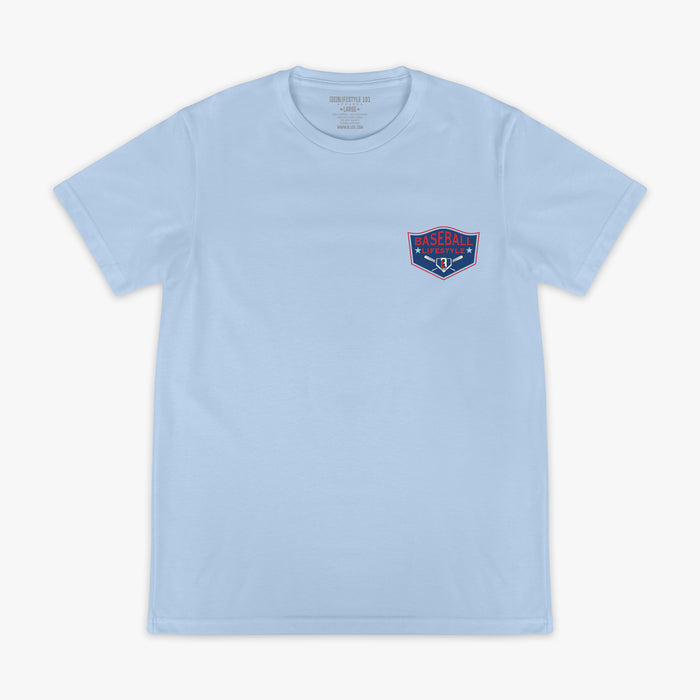 Front flat lay of the BL101 Baseball League Champions light blue tee, showing the Baseball Lifestyle shield chest logo on a white background.