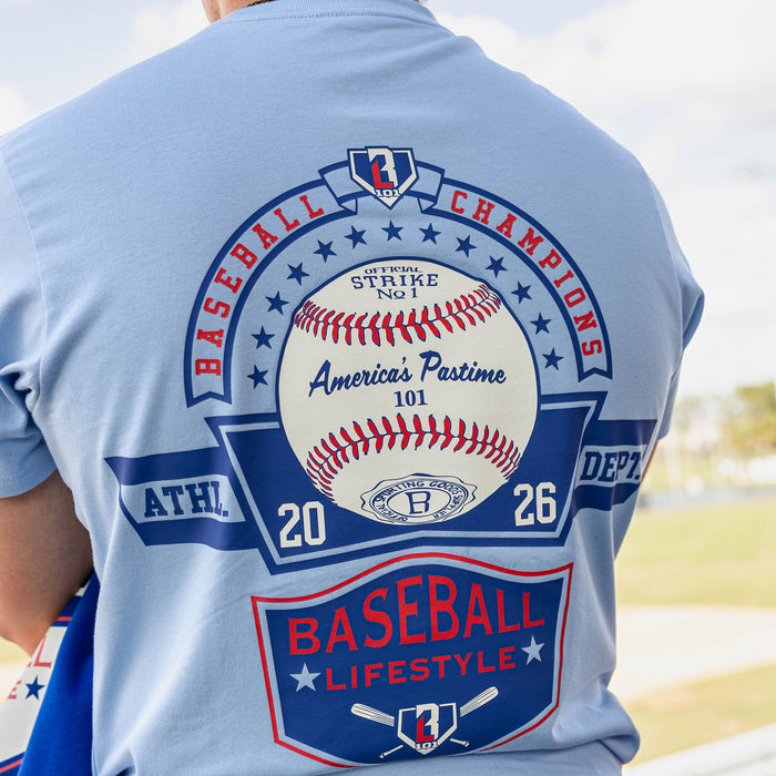 Close up of light blue tee back graphic featuring a Baseball Champions circle design with a baseball center America's Pastime 101 text and Baseball Lifestyle shield below