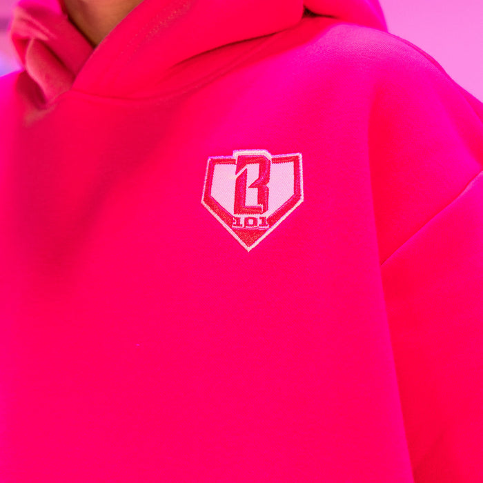 Youth model wearing pink Baseline youth hoodie