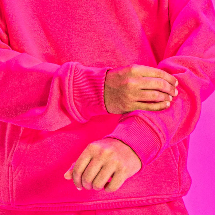 Youth model wearing pink Baseline youth hoodie