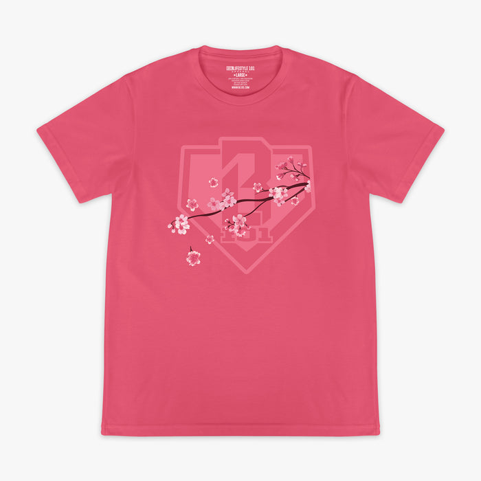 Pink BL101 tee with a tonal cherry blossom branch and home plate shield logo graphic on the chest, flat lay front view