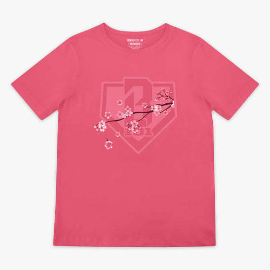 Pink BL101 tee with a tonal cherry blossom branch and home plate shield logo graphic on the chest, flat lay front view