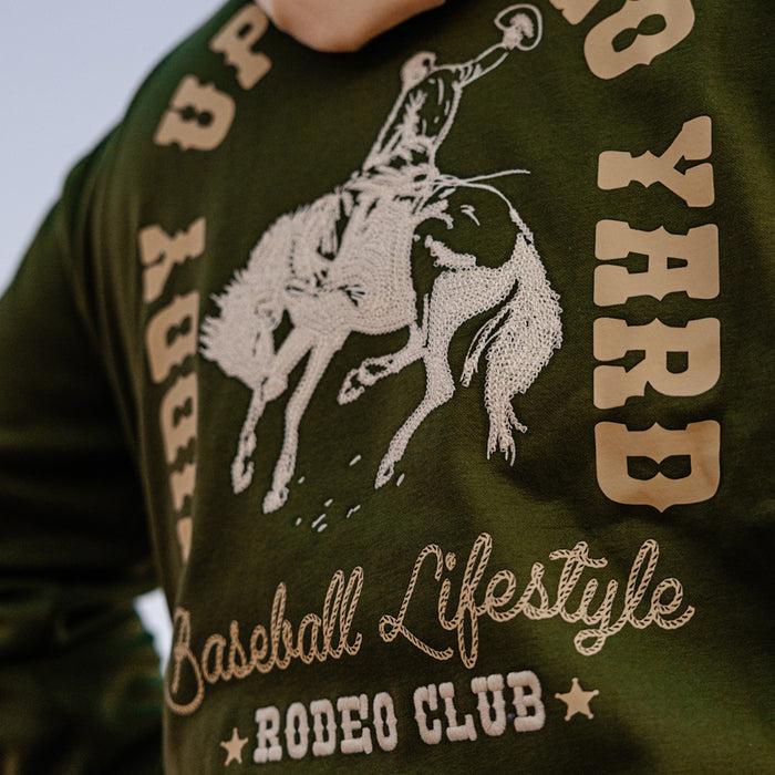 Green hoodie with white graphic of a rodeo scene and text on a person wearing it.