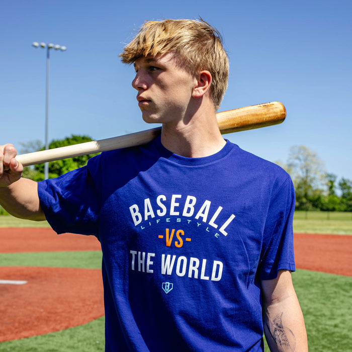 Adult model wearing navy graphic tee with "BL101 Vs The World" design