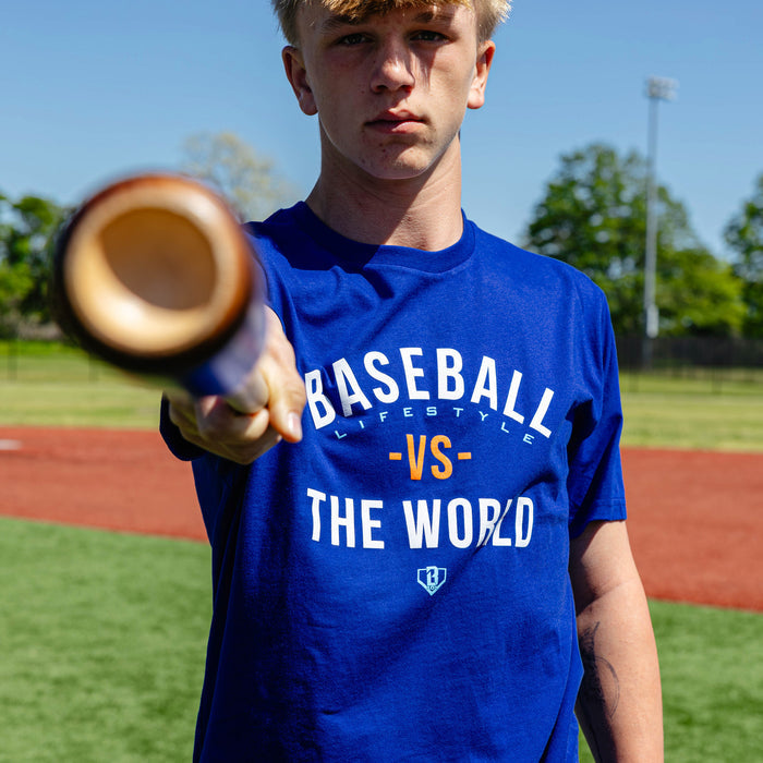 Adult model wearing navy graphic tee with "BL101 Vs The World" design
