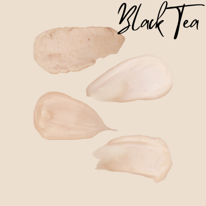 Swatches of Black Tea Manicure cream, scrub and lotions on a soft peach background