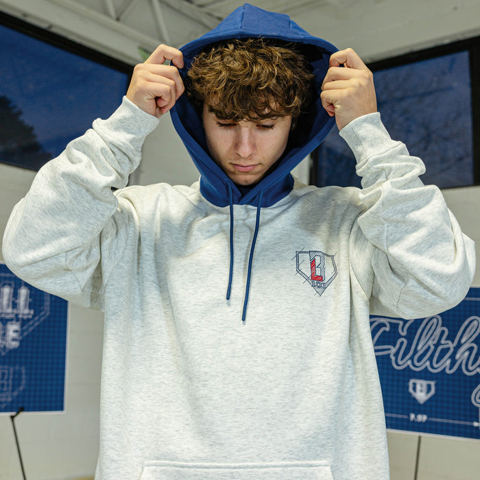 Person wearing a gray hoodie with blue hood with a blue an red BL101 logo