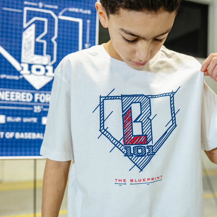 Person wearing a white t-shirt with a BL101 logo and 'The Blueprint' text, standing in front of a blue and white graphic background.