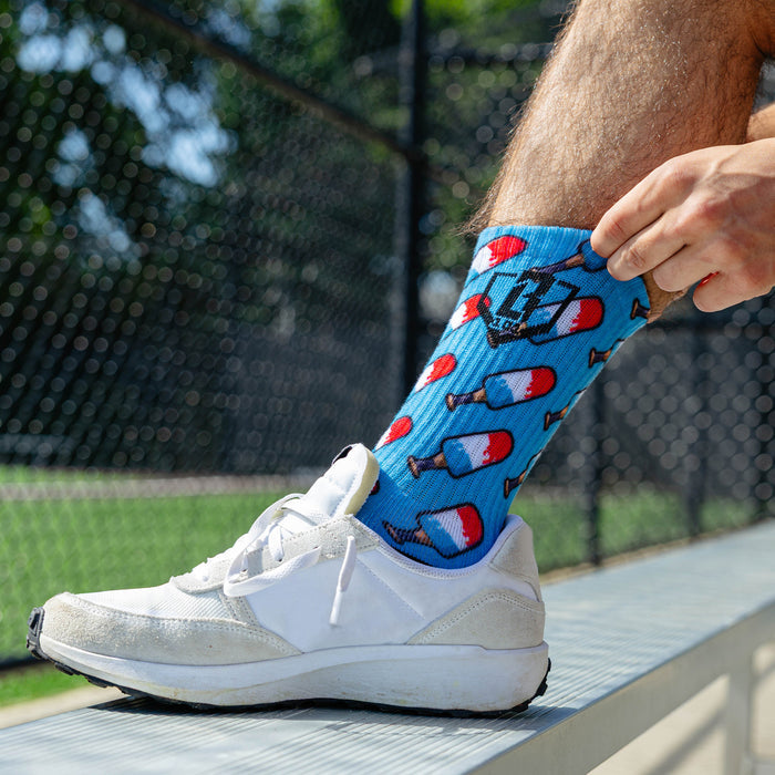 Adult model wearing red, white & blue socks with "Freeze Pop Performance  3-Pack" design