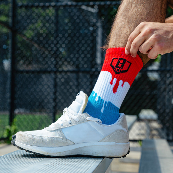 Adult model wearing red, white & blue socks with "Freeze Pop Performance  3-Pack" design