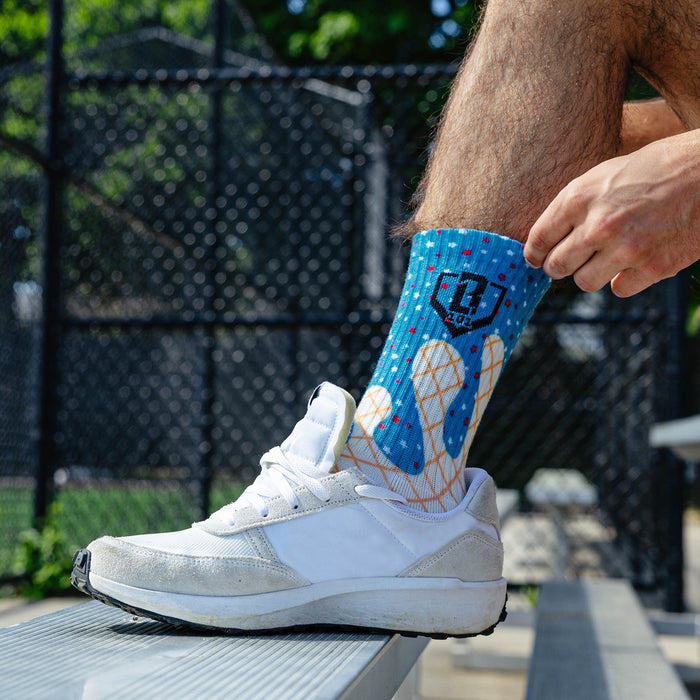Adult model wearing red, white & blue socks with "Freeze Pop Performance  3-Pack" design