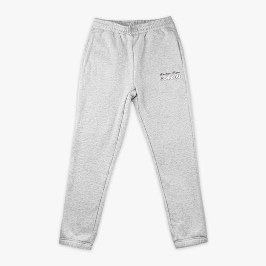 Gray sweatpants with a Jackson Olson BL101 logo on the left leg against a white background