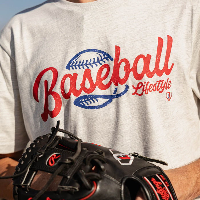 Close-up of the vintage-style Baseball Lifestyle script graphic on the heather gray tee, with a baseball glove in the foreground.