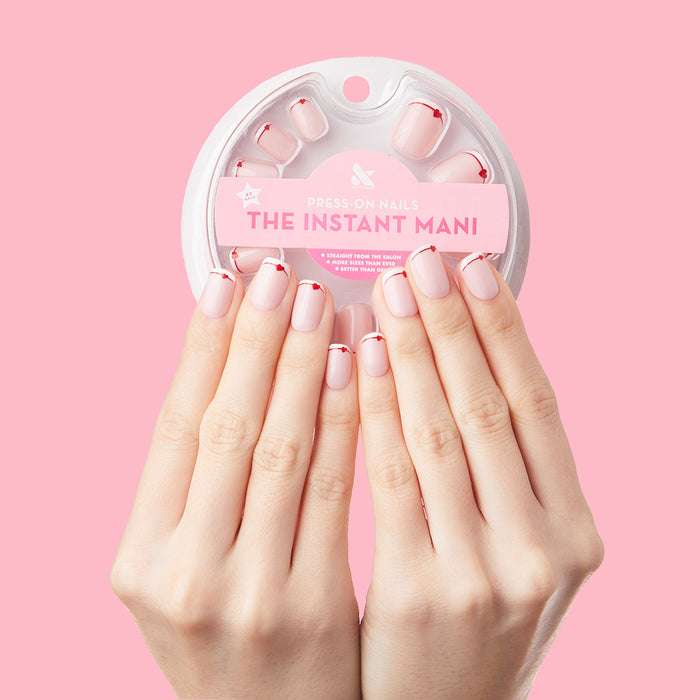 Classic French with CV Heart - Squoval | Extra Short press-on nails with peachy pink base, white tips, and small red heart accents on hands