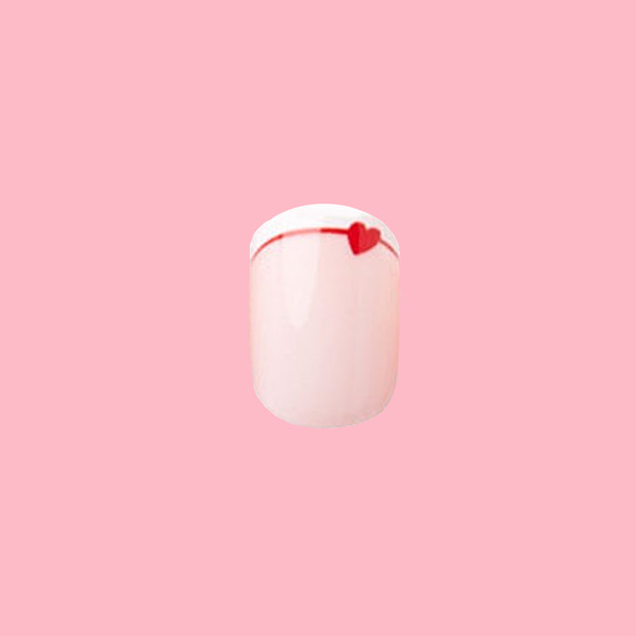 Classic French with CV Heart - Squoval | Extra Short with peachy pink base, white tip, and small red heart nail design on pink background
