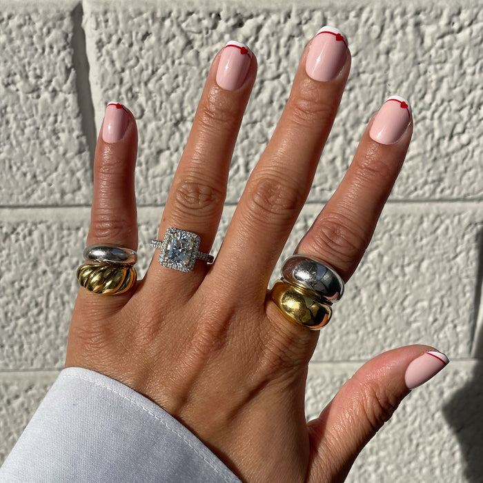 Classic French with CV Heart - Squoval | Extra Short press-on nails with peachy pink base and red heart outline tips on hand