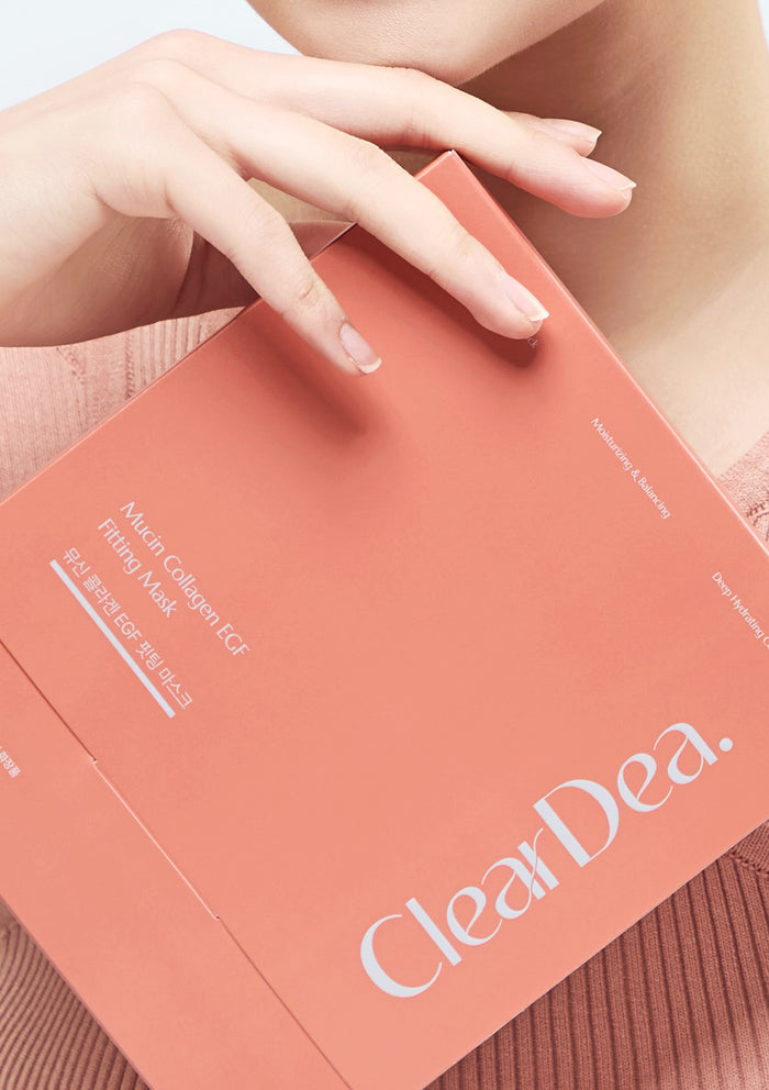 Person holding a ClearDea mask package with a focus on the brand name.