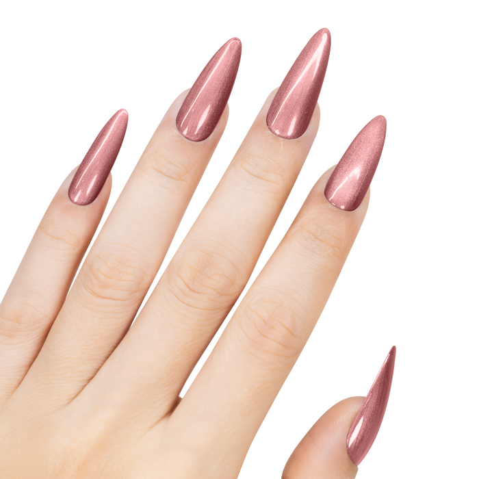 Hand with long, pointed nails painted in a metallic pink color on a white background