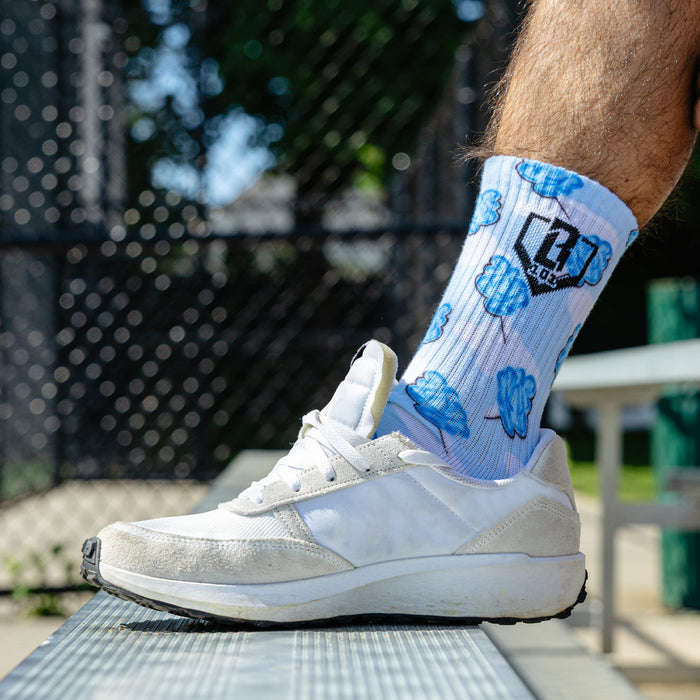 Adult model wearing multi-color socks with "Cotton Candy Performance  3-Pack" design