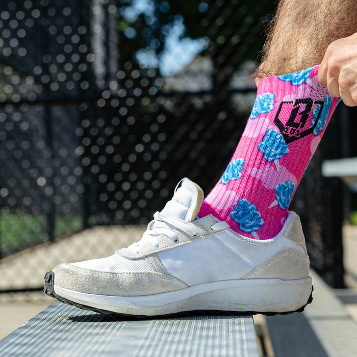 Adult model wearing multi-color socks with "Cotton Candy Performance  3-Pack" design