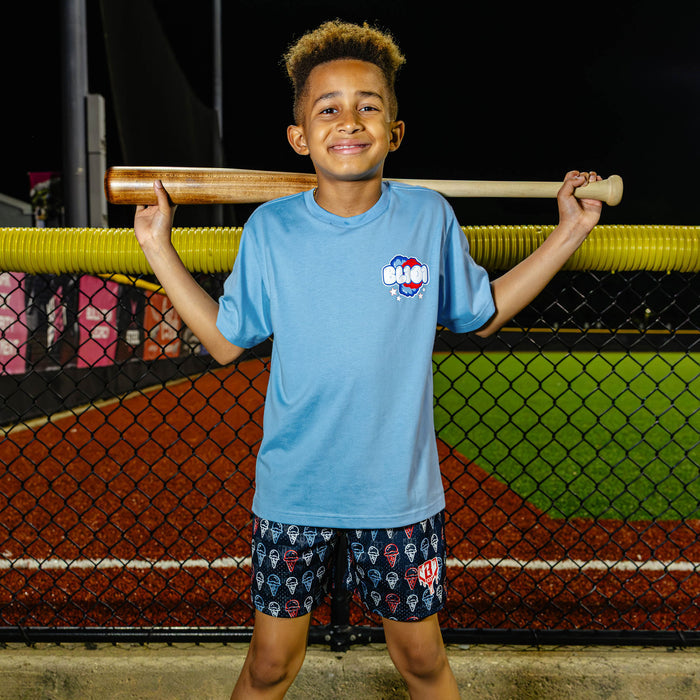 Youth model wearing red, white & blue Cotton Candy Light Blue youth graphic tee