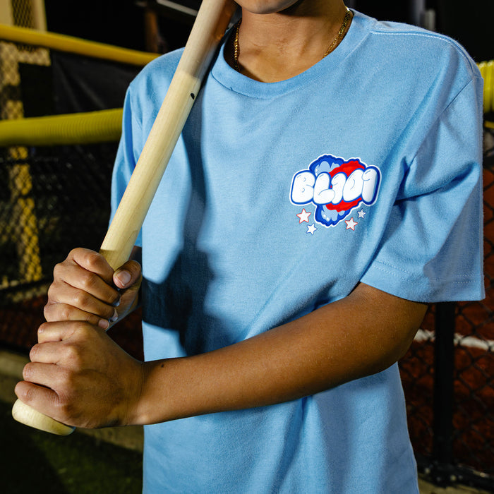 Youth model wearing red, white & blue Cotton Candy Light Blue youth graphic tee