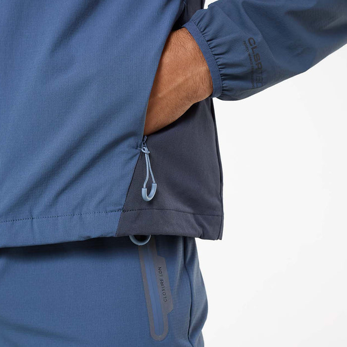 Close up of men's Cyclone Contrast Tracksuit Jacket in steel blue– reflective chest logo and cuff detail