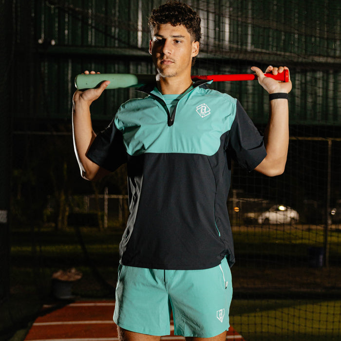 Adult model wearing black and teal Diamond Tech Pro Cage Jacket jacket
