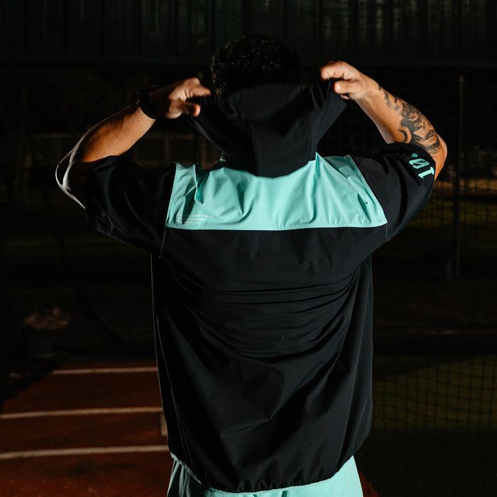 Adult model wearing black and teal Diamond Tech Pro Cage Jacket jacket