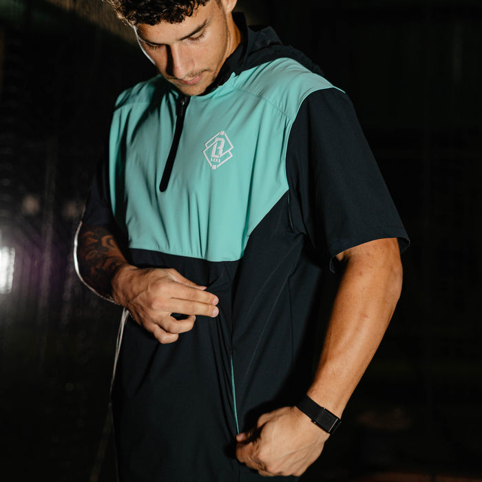Adult model wearing black and teal Diamond Tech Pro Cage Jacket jacket