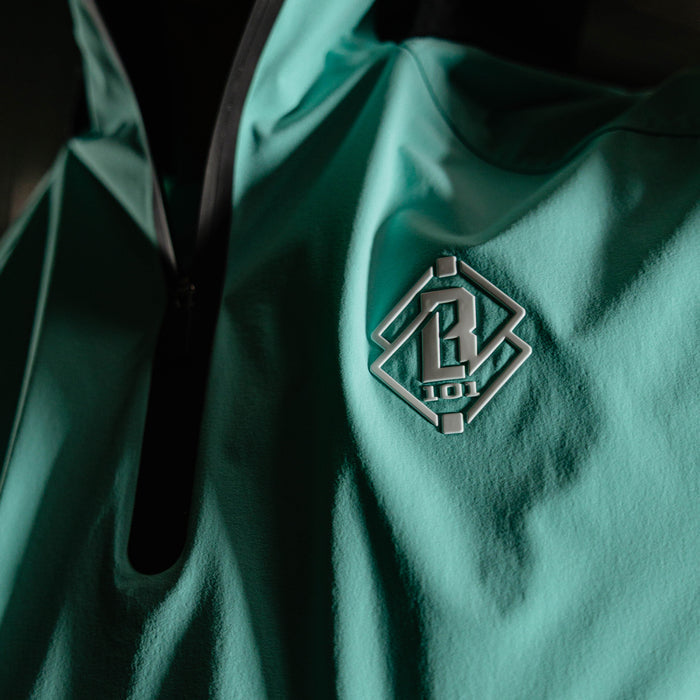 Adult model wearing black and teal Diamond Tech Pro Cage Jacket jacket