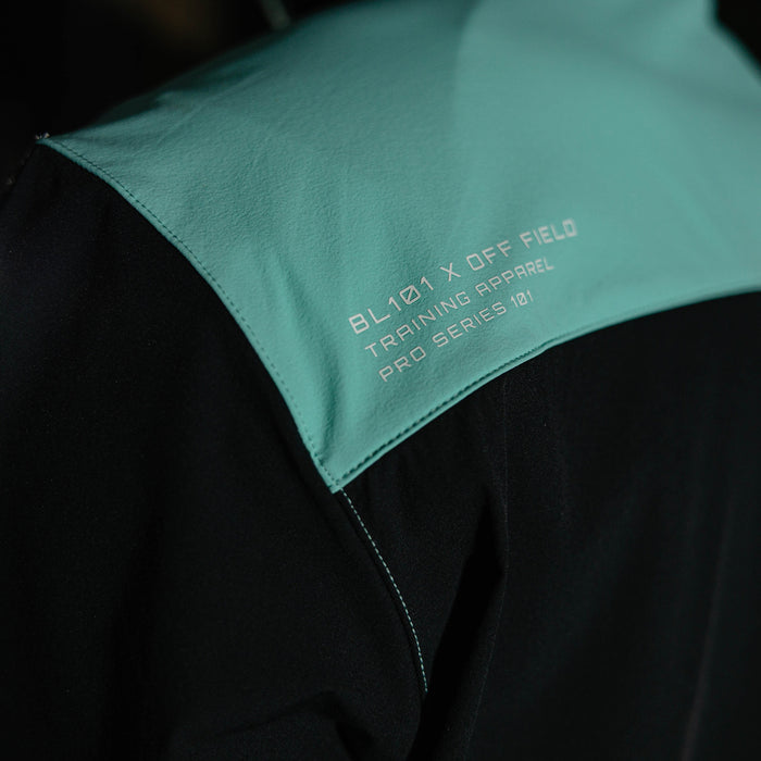 Adult model wearing black and teal Diamond Tech Pro Cage Jacket jacket