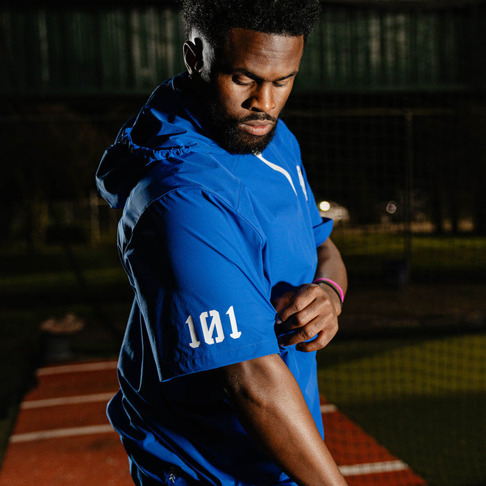 Adult model wearing blue Diamond Tech Pro Cage Jacket Royal Blue jacket