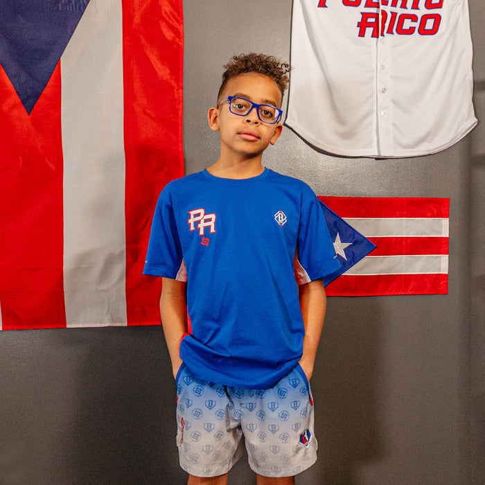 Youth model wearing blue Diamond Tech Vented Puerto Rico youth graphic tee