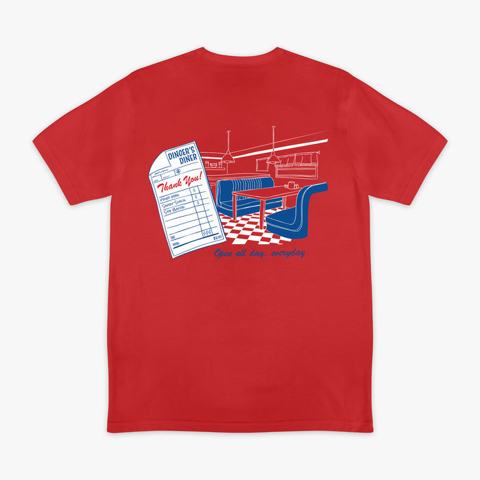 Red t-shirt with a graphic design on the back featuring a restaurant scene and checkered floor.