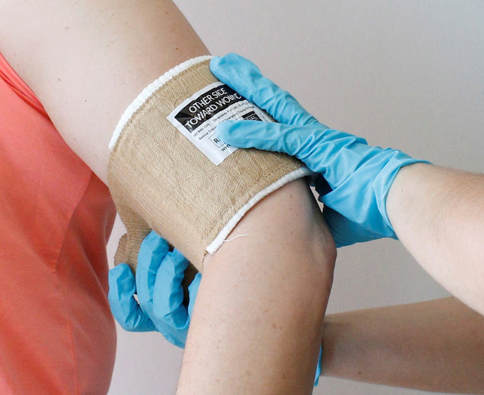 Rescue Essentials Emergency Trauma Dressing, in use on arm